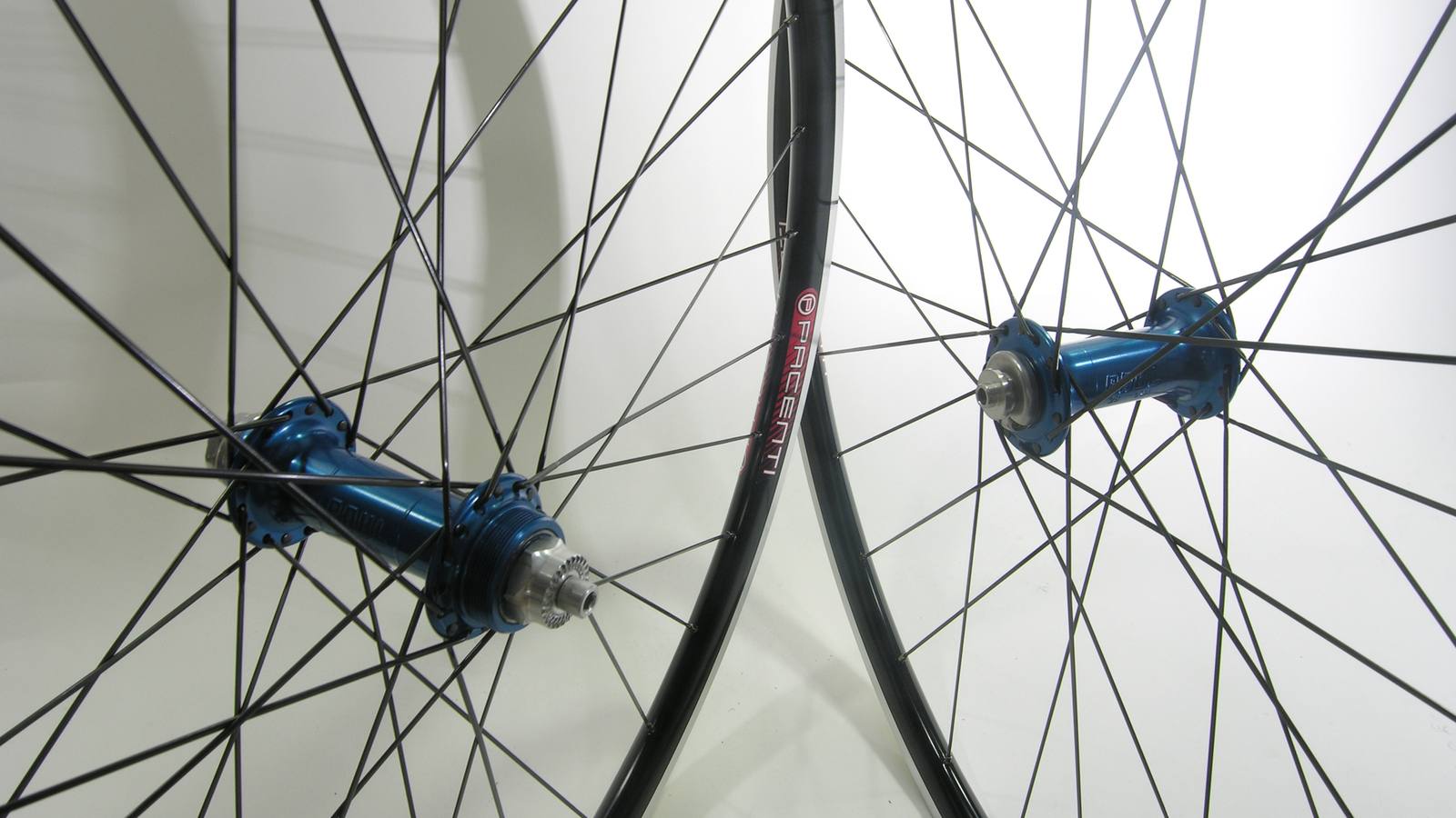 Custom wheel built by ProWheelBuilder: Paul Word Blue hubs, Pacenti Sl23 Black rims