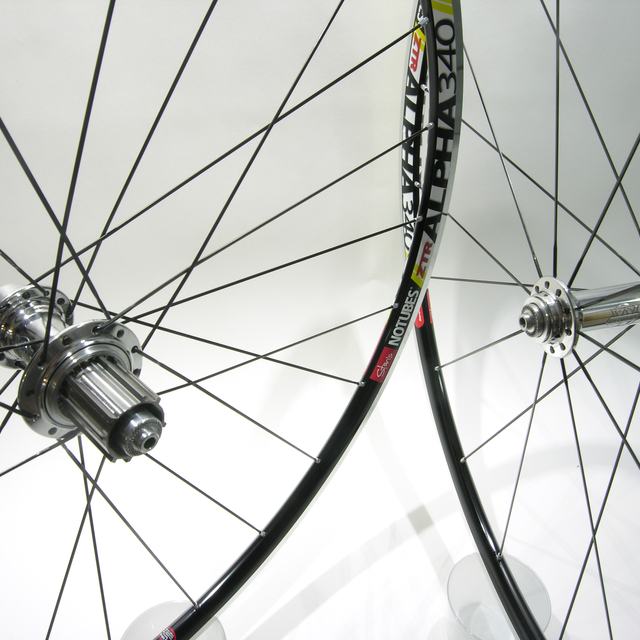 Custom wheel: White Industries T11 Polished hubs, Stan's Alpha 340 Black rims, Sapim CX-Ray Black spokes