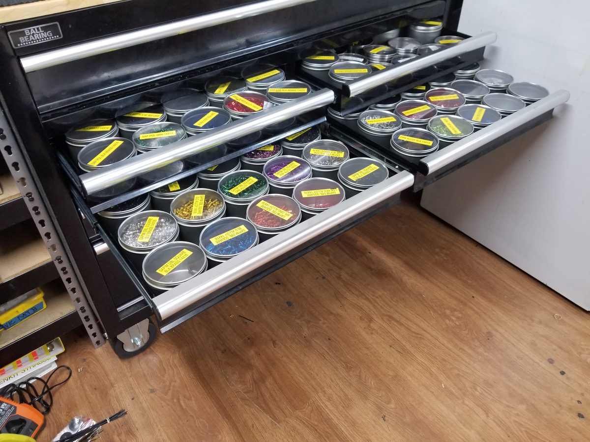 Toolbox drawers of labeled tins holding nipples in every color and size