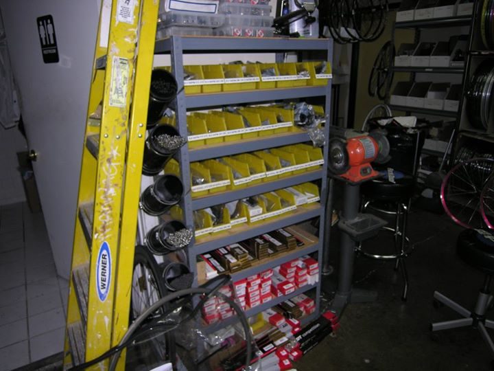 Shelves of sorted small parts bins in the early ProWheelBuilder shop