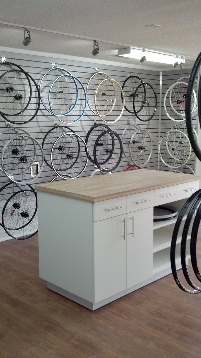 The showroom wall of hand-built wheels on slatwall displays