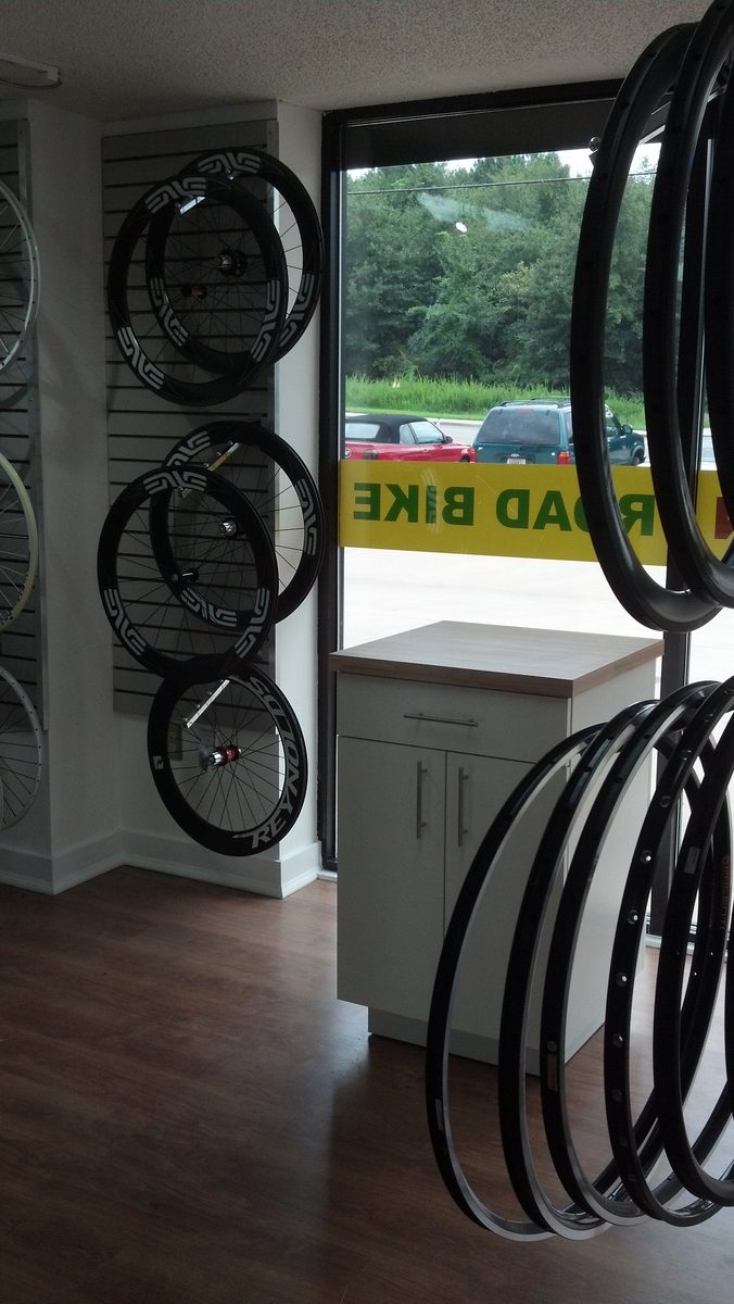 Deep-section carbon wheels displayed by the showroom window